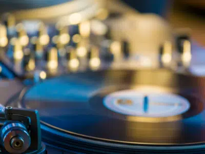 A dj is playing music on a turntable.