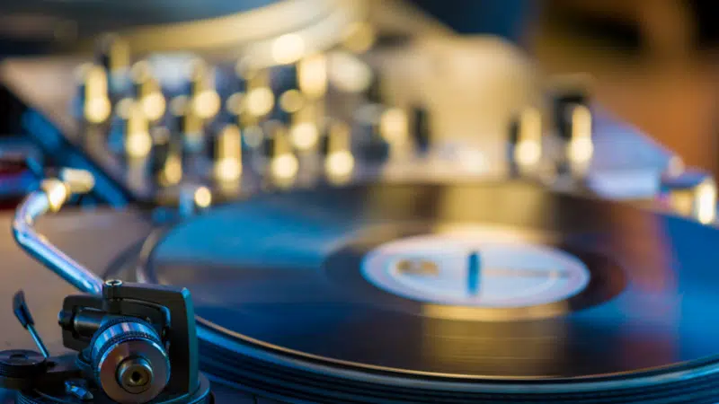 A dj is playing music on a turntable.