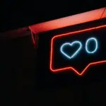 A neon sign with a heart on it.