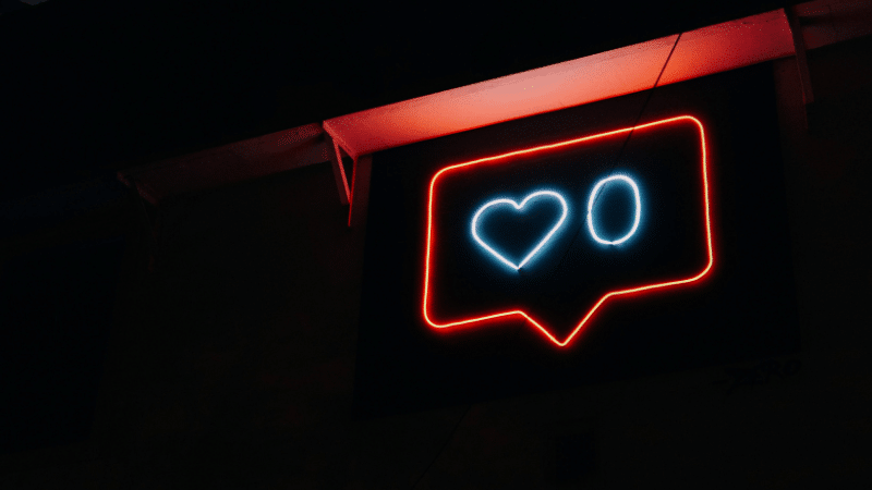 A neon sign with a heart on it.