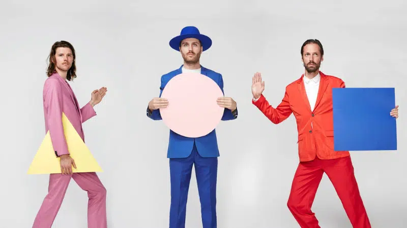 A group of men in colorful suits and hats posing for a picture.