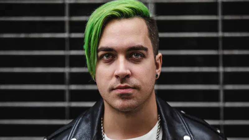 A man with green hair in a leather jacket.