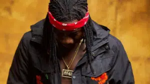 A man with dreadlocks and a red bandana.