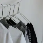 Black and white shirts hanging on a clothes hanger.