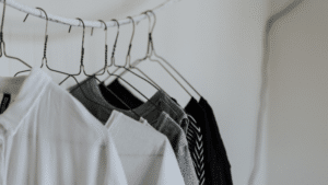 Black and white shirts hanging on a clothes hanger.