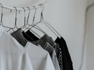 Black and white shirts hanging on a clothes hanger.