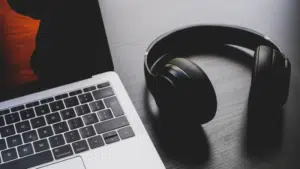 A laptop and headphones on a table.