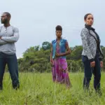 A group of people standing in a field.