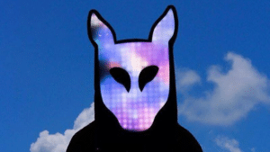 A man wearing a mask with a blue and purple background.