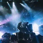 A group of people on stage at a concert.