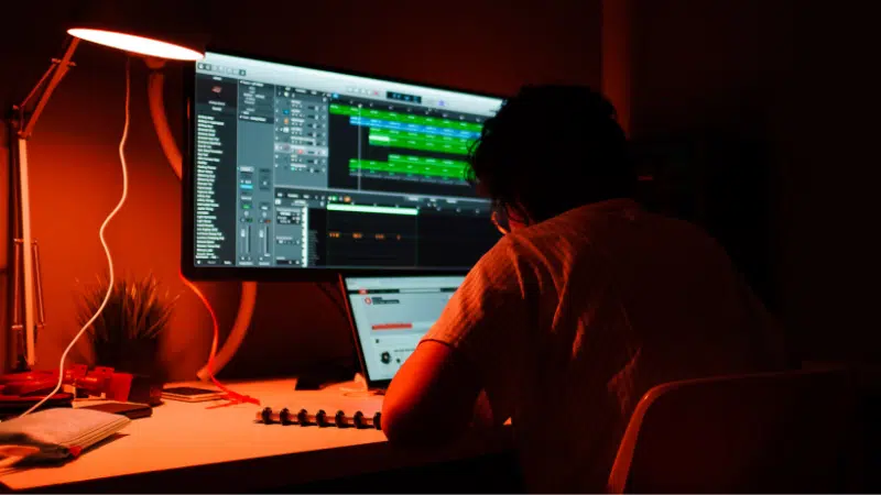 A person working on a computer in a dark room.