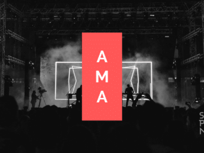 A black and white image of a concert with the words ama.