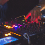 A group of djs playing music at a party.