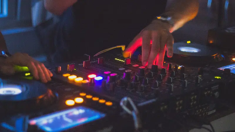 A group of djs playing music at a party.