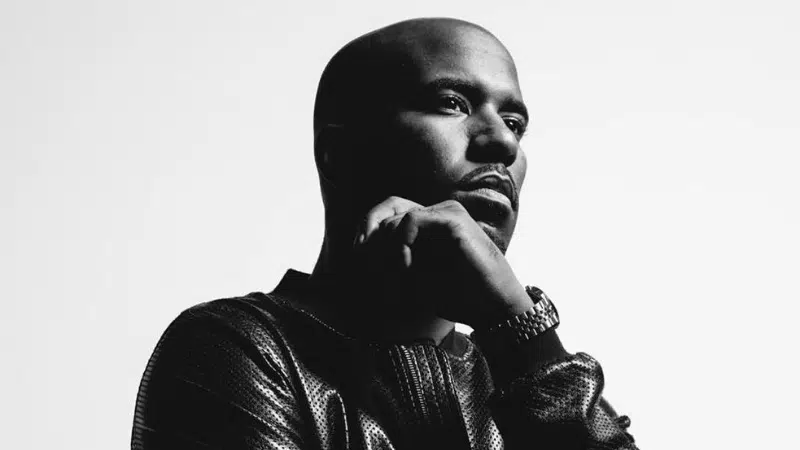 A black and white photo of a man in a leather jacket.