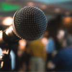 A microphone in front of a crowd of people.