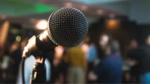 A microphone in front of a crowd of people.