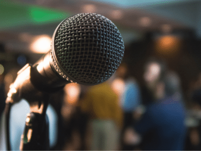 A microphone in front of a crowd of people.