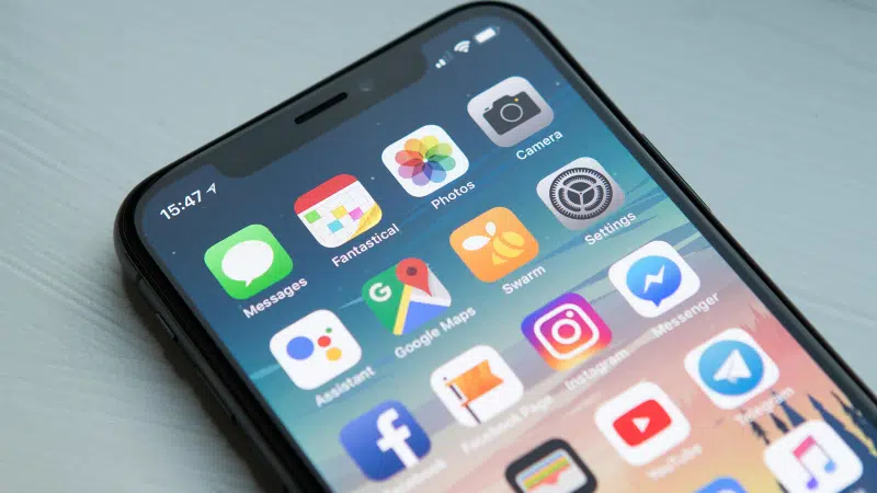 The iphone x is shown on a table.