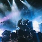 A group of people performing on stage at a festival concert.