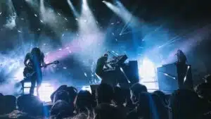 A group of people performing on stage at a festival concert.