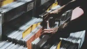 A person physically picking up a stack of records.