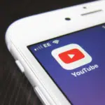 A close up of a phone featuring YouTube Premiere.