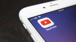 A close up of a phone featuring YouTube Premiere.