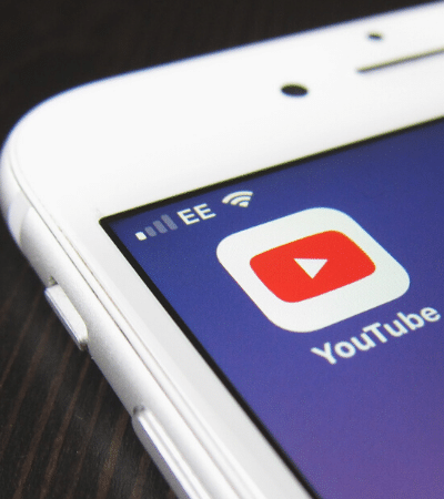 A close up of a phone featuring YouTube Premiere.