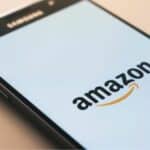 The Amazon logo is displayed on a smartphone.