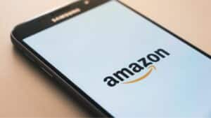 The Amazon logo is displayed on a smartphone.