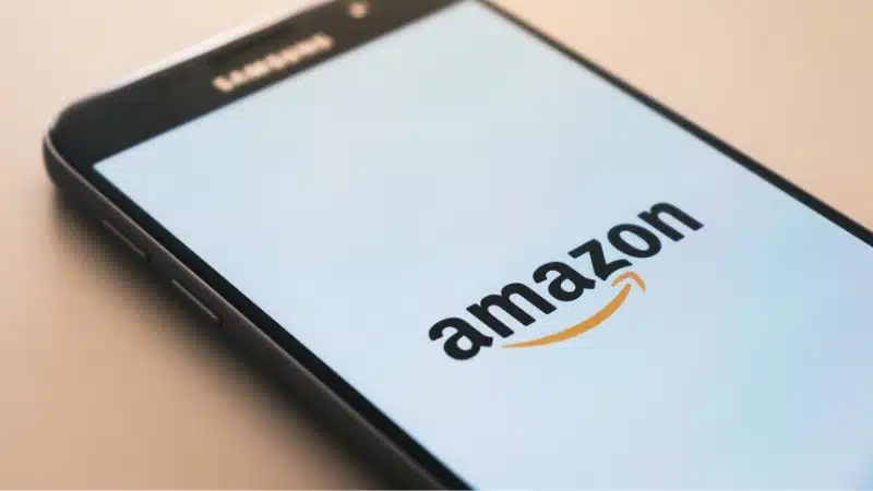 The Amazon logo is displayed on a smartphone.