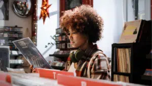 girl listening to music at a record store