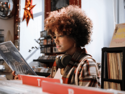 girl listening to music at a record store