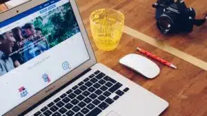 A laptop advertising online sitting on a wooden table.