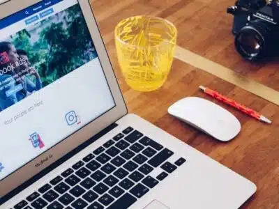 A laptop advertising online sitting on a wooden table.