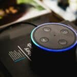 An Echo Dot sits on top of a book, showcasing Amazon Music capabilities.
