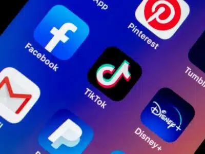 A phone screen displays TikTok and social media icons.