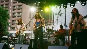 Music Manager working with outdoor musicians on stage.