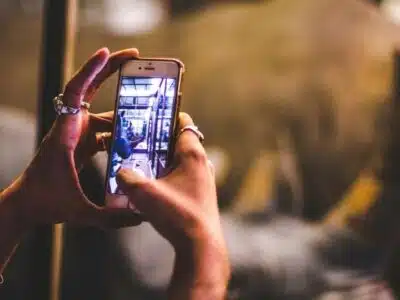 A person using their cell phone to take a picture for a TikTok video.