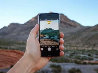 A person showcasing IG Reels with a picture of a mountain in the background.