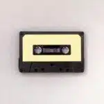 A cassette tape on a white surface demonstrating how to clear a sample.