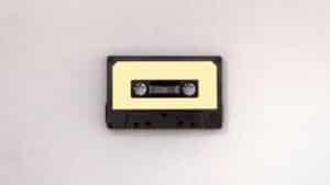 A cassette tape on a white surface demonstrating how to clear a sample.