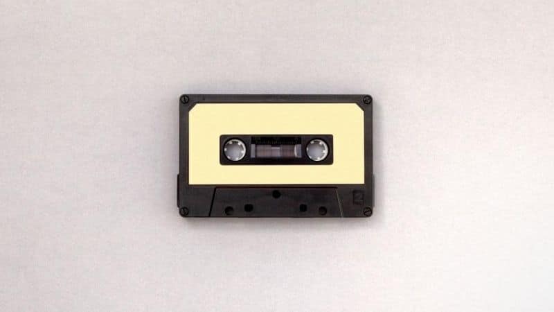 A cassette tape on a white surface demonstrating how to clear a sample.