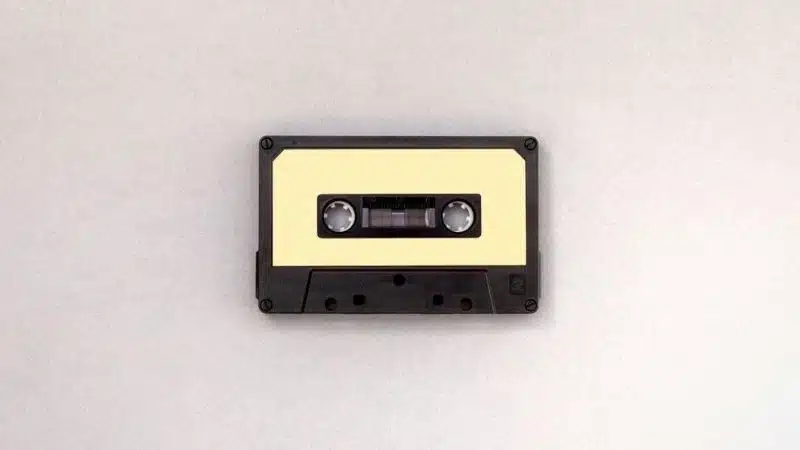 A cassette tape on a white surface demonstrating how to clear a sample.