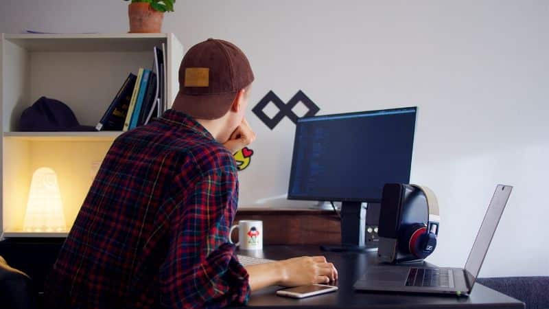 A music supervisor working at a desk with a computer.