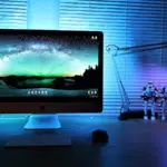 A desk with a monitor on it.