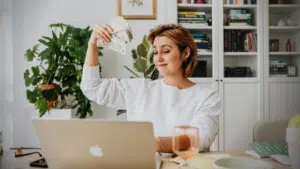 A woman sitting at a desk with money in her hands, representing an image often associated with producers.