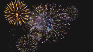 A vibrant fireworks display illuminating the night sky to celebrate the year in review.