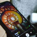 A phone with a picture of a clock on it, featuring Spotify Canvas.